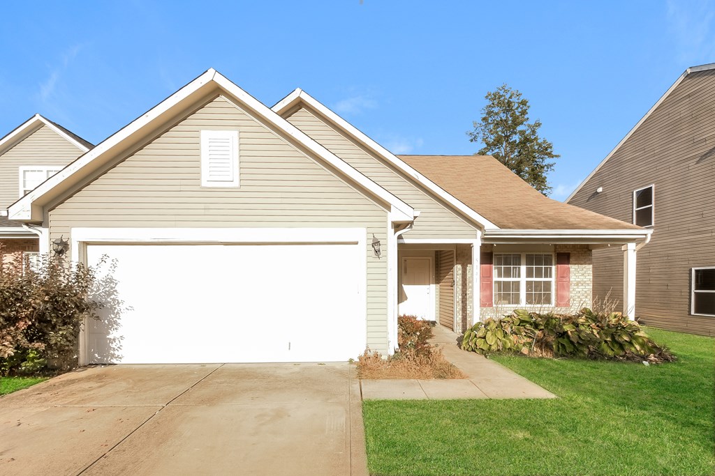 A house with a garage and a driveway.