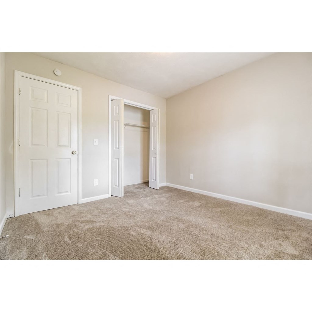 a bedroom with a closet and a door