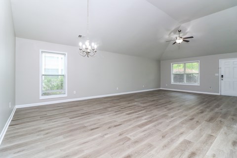A room with a ceiling fan and a chandelier.