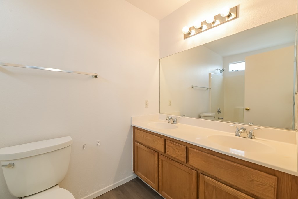 A white toilet sits next to a white sink in a bathroom.