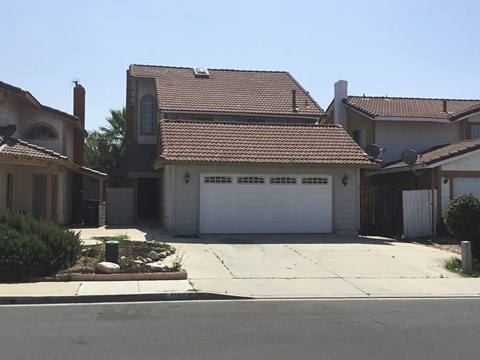 a white garage door in front of a house