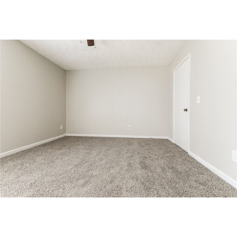 an empty room with carpet and a door
