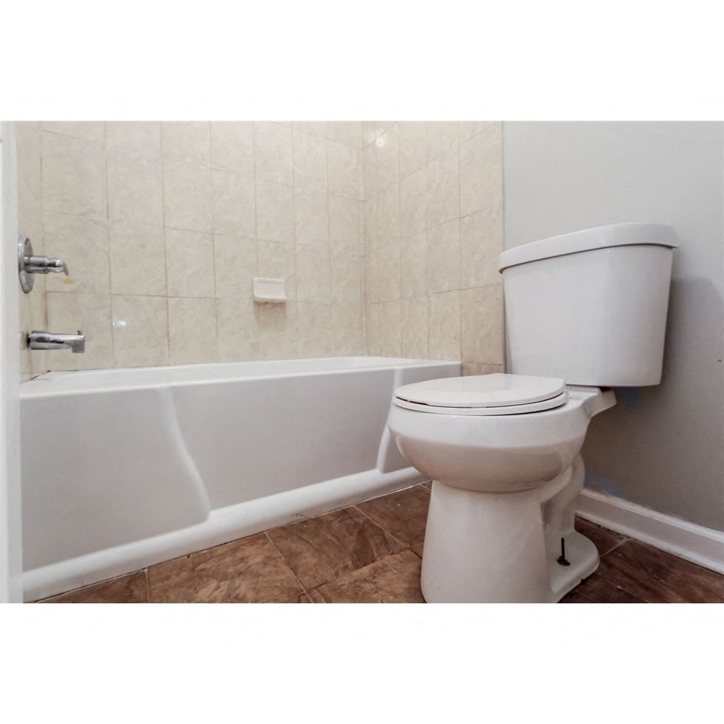 a bathroom with a toilet and a tub