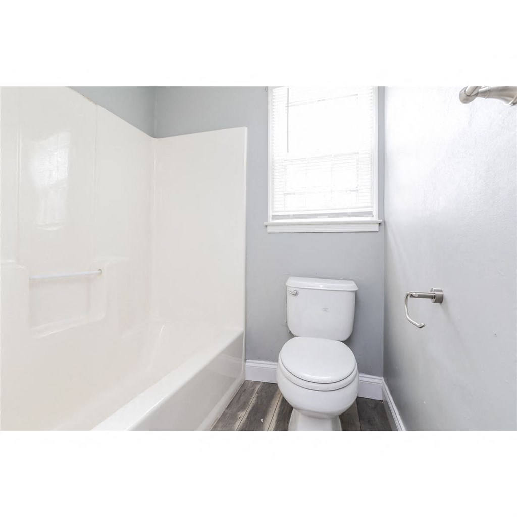 a small bathroom with a toilet and a tub