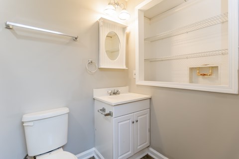 A white toilet sits next to a sink in a small bathroom.
