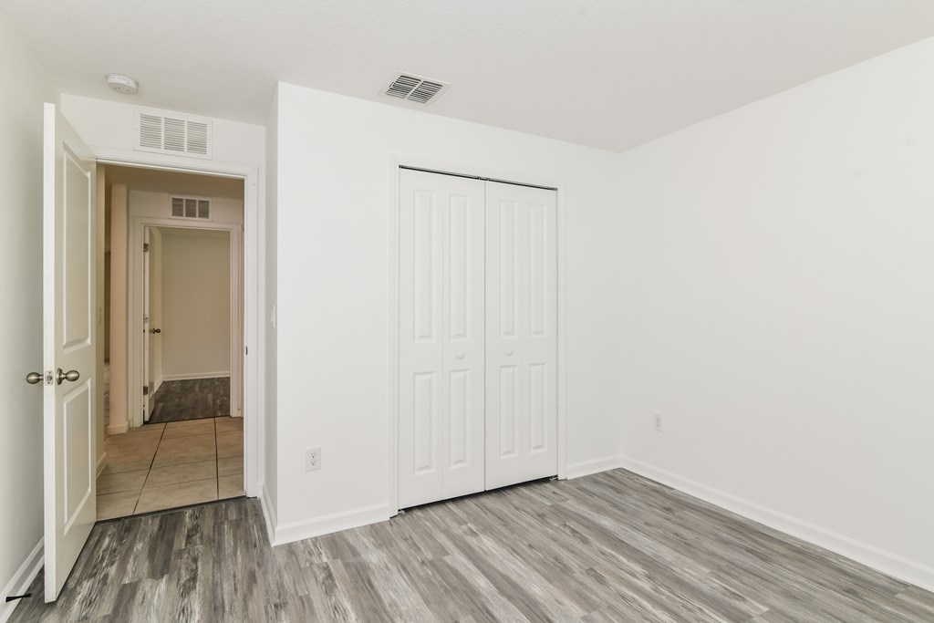 A room with a white door and a white closet door.