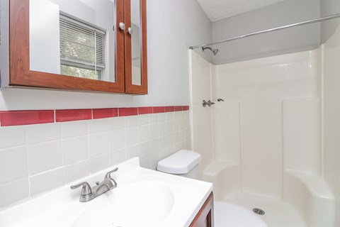 A white sink with a silver faucet and a white towel holder.