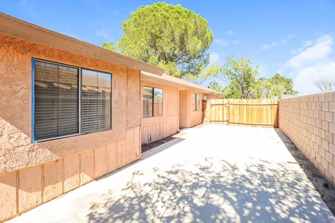 A house with a brown exterior and a white driveway.