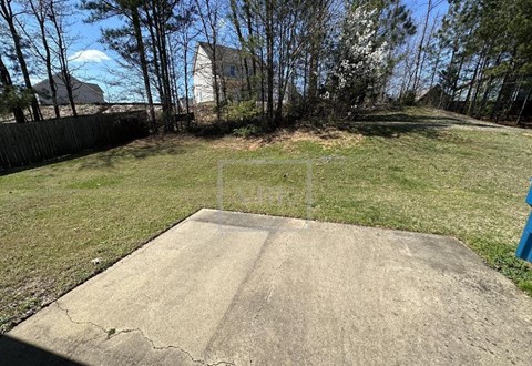 A concrete slab in the foreground with a residential area in the background.