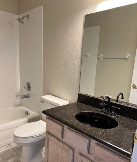a bathroom with a sink toilet and a mirror