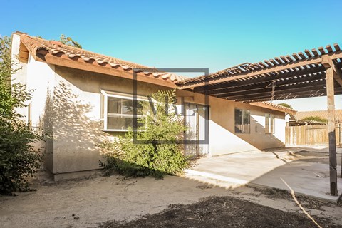 A house with a white exterior and a brown roof.