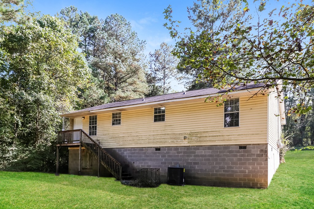 A house with a wooden exterior and a balcony.