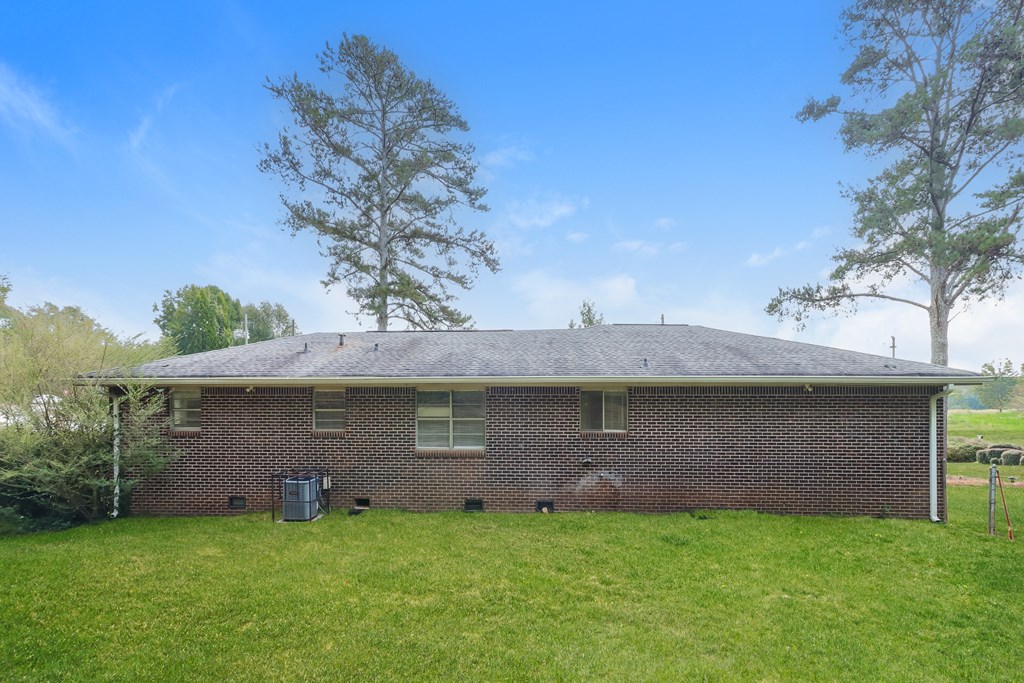 A house with a grey roof and a green lawn.