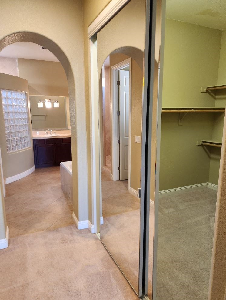 a view of a bathroom with a mirrored door