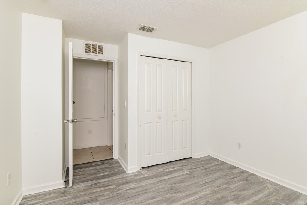 A room with a white door and a white wall.