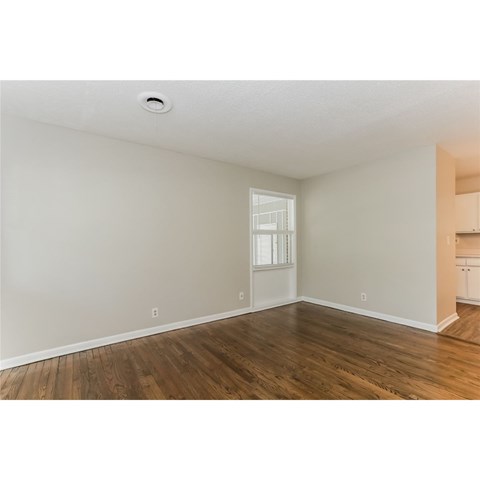 A room with wooden floors and white walls.