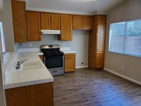 A kitchen with wooden cabinets and a white countertop.