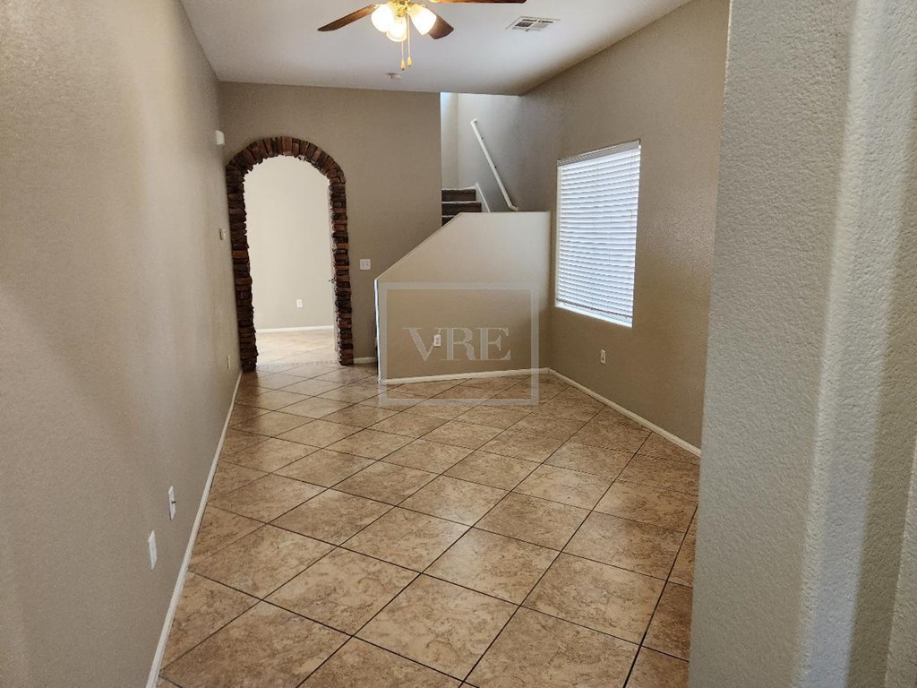 A room with a tiled floor and a ceiling fan.