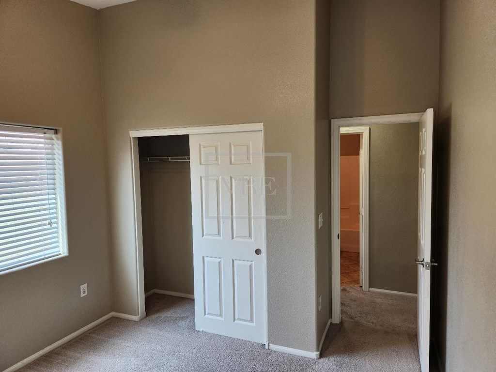 A white door is in a room with a carpet floor.