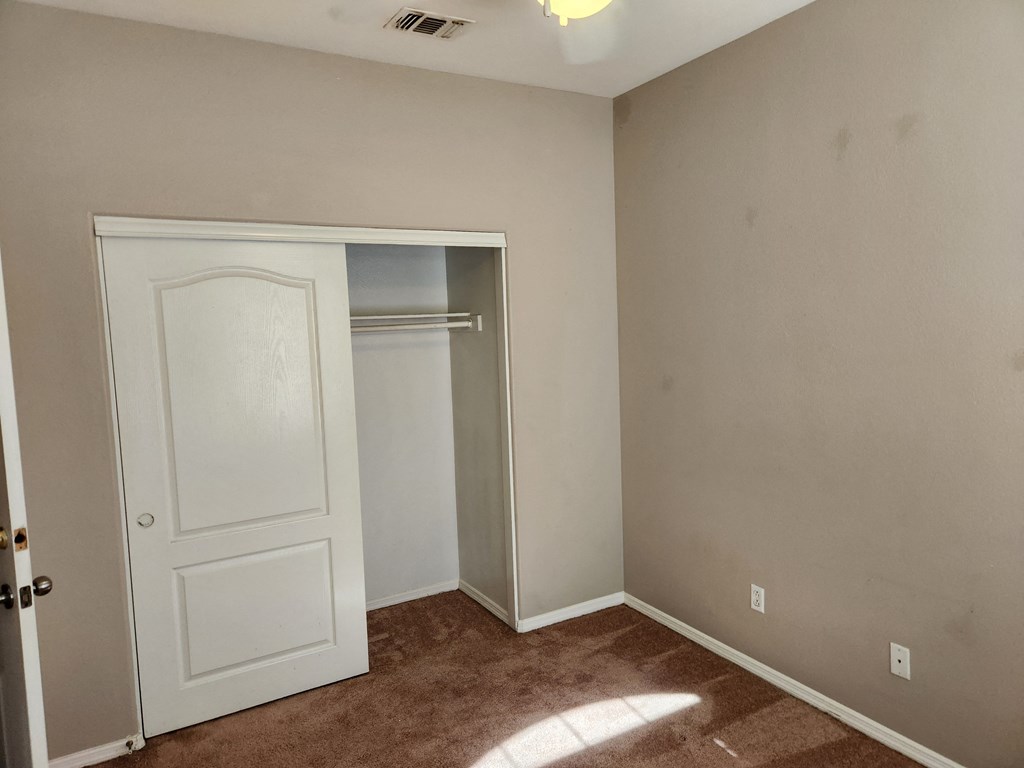 a bedroom with a closet and a door to a closet