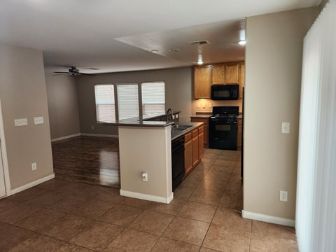 A kitchen with a counter and a microwave.
