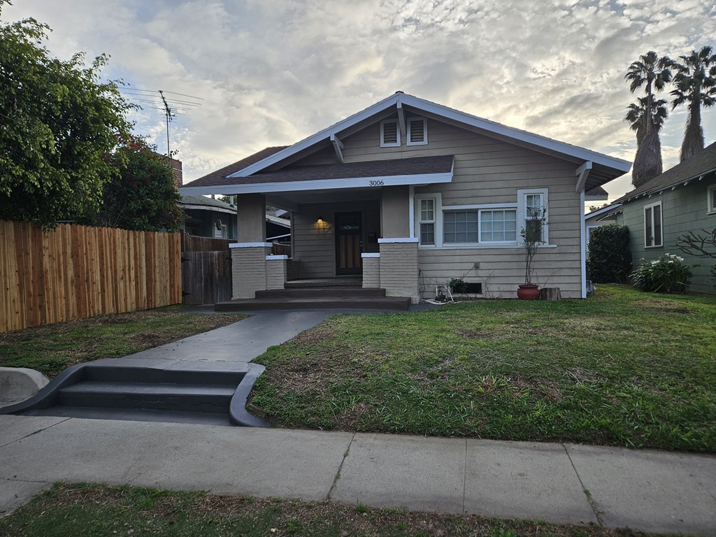 A house with a grey roof and a brown fence.