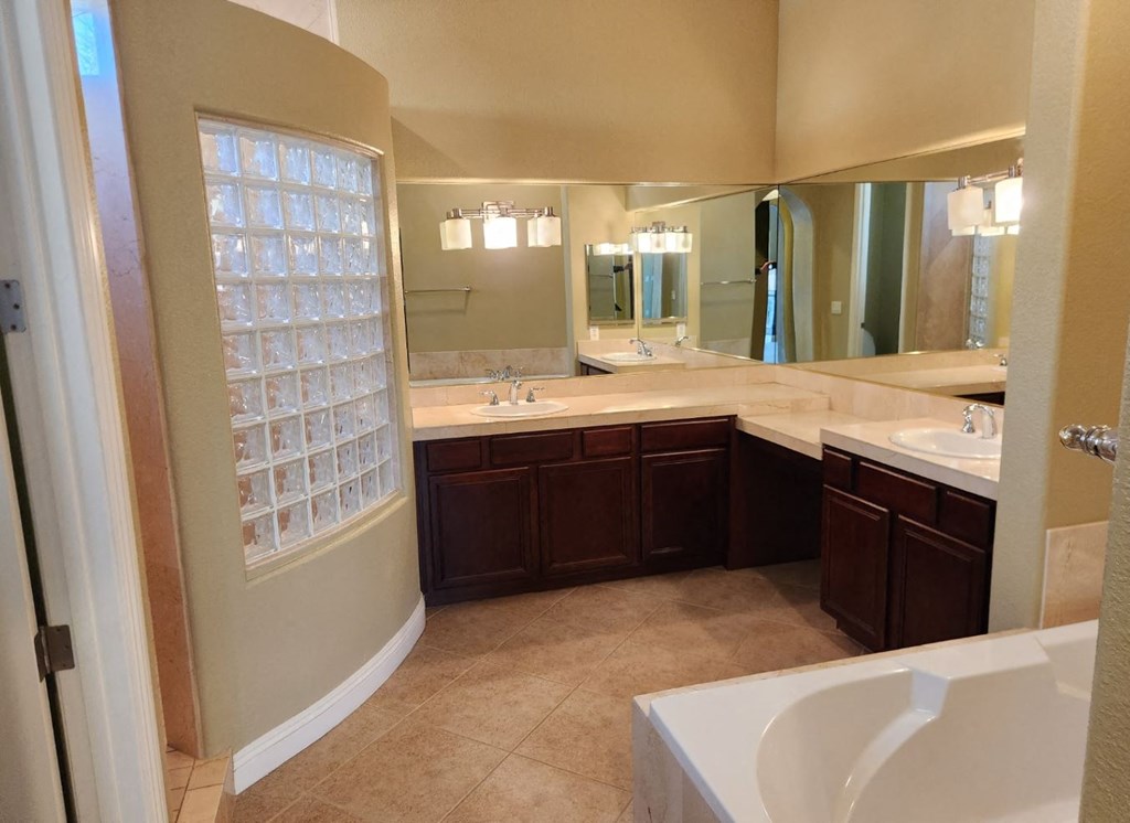 a bathroom with two sinks and a large mirror