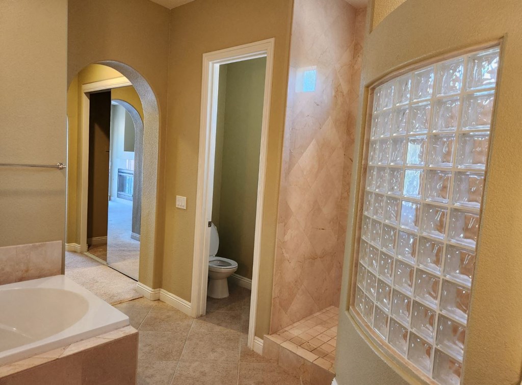 a bathroom with a shower and a sink and a toilet