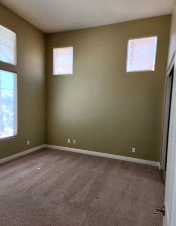 an empty room with brown walls and a wooden floor