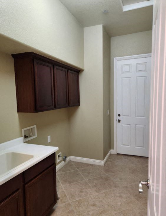 a bathroom with a sink and a white door