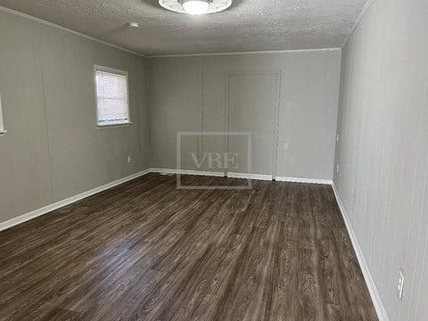 a small living room with a hard wood floor