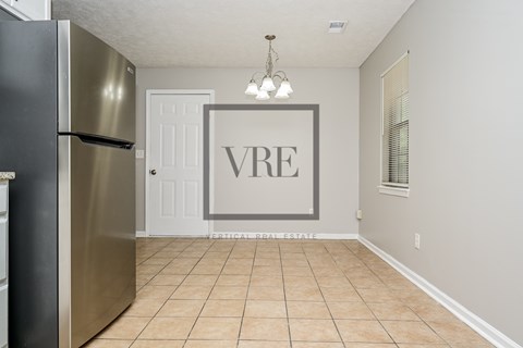A kitchen with a refrigerator and a sign that says VRE.
