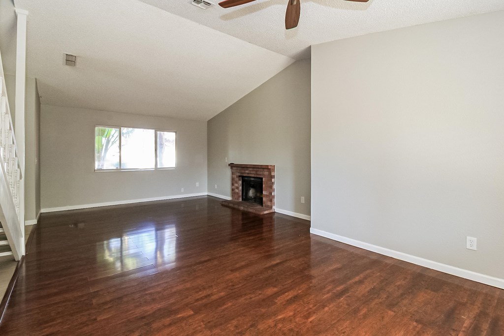 A room with a fireplace and a window.