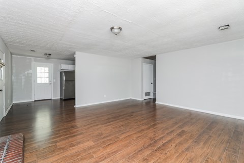 A room with wooden floors and white walls.