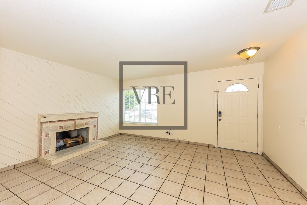 A room with a fireplace and a picture frame on the wall.
