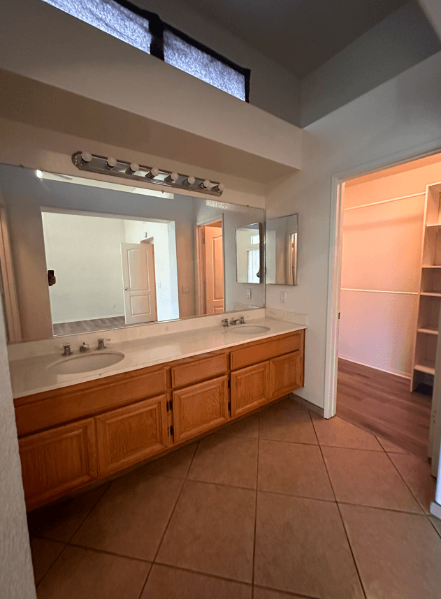 a large bathroom with two sinks and a large mirror