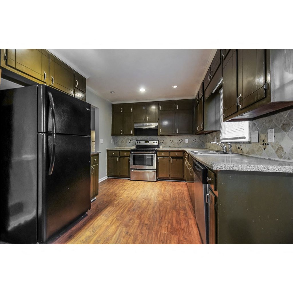 a kitchen with stainless steel appliances and black cabinets