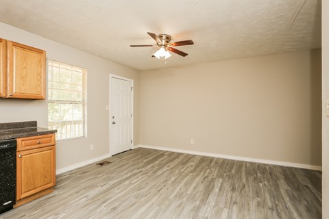 A kitchen with wooden cabinets and a black countertop.