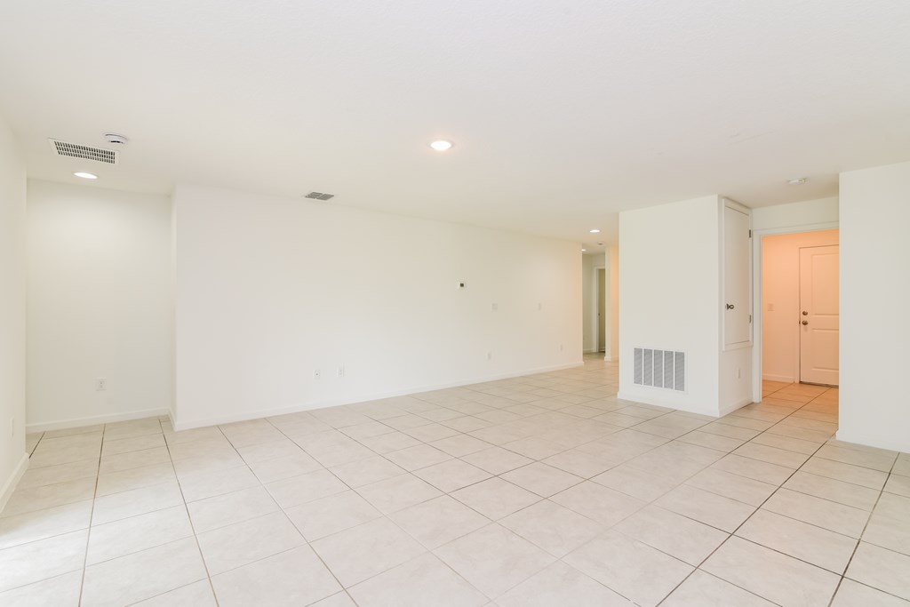 A large empty room with white walls and floor.