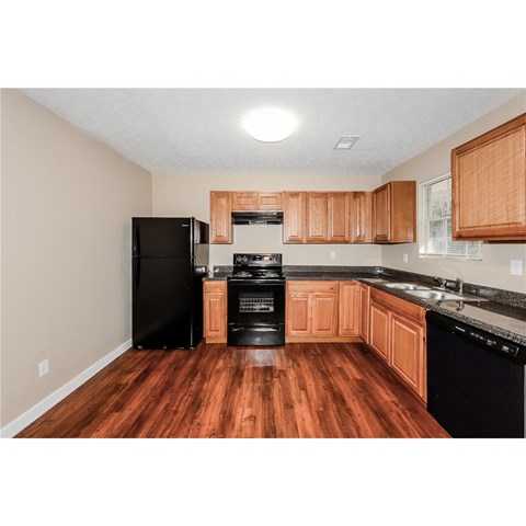 a kitchen with black appliances and wooden cabinets