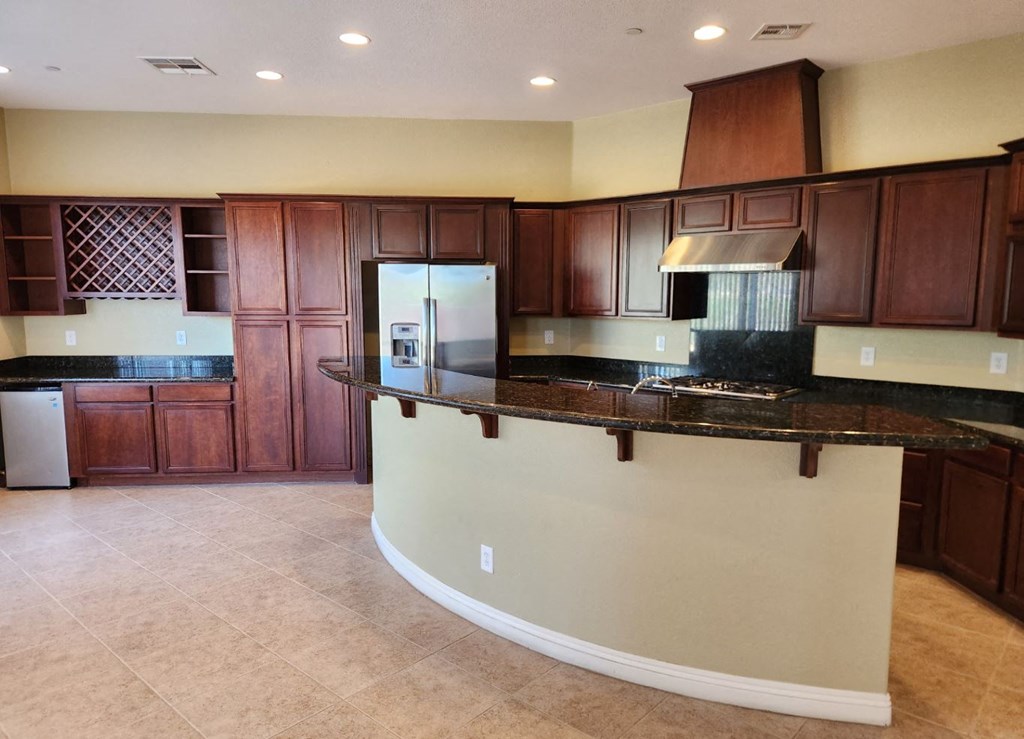 a kitchen with a counter top and a refrigerator