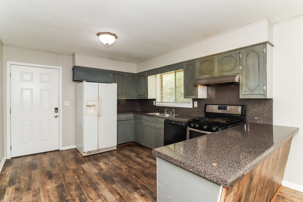 A kitchen with a stove top oven and a microwave.