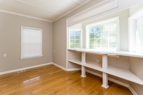 A room with a window and a bench.