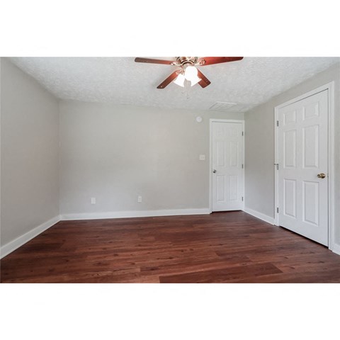 a bedroom with a ceiling fan and a closet