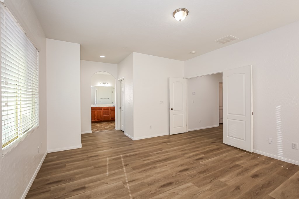 A room with white walls and wooden flooring.
