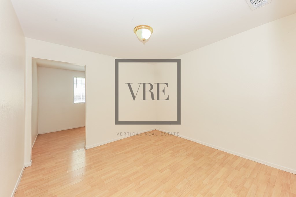 A room with a wooden floor and a wall with a sign that says VRE.