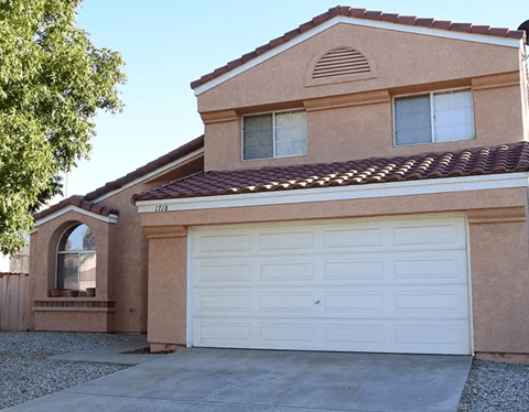 A house with a brown roof and a white garage door.