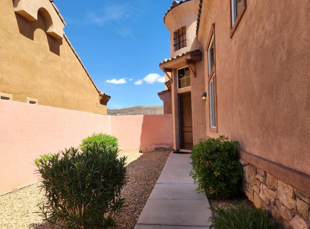 the walkway to the front door of a desert house