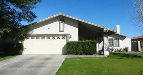 A house with a white garage door and a white wall.