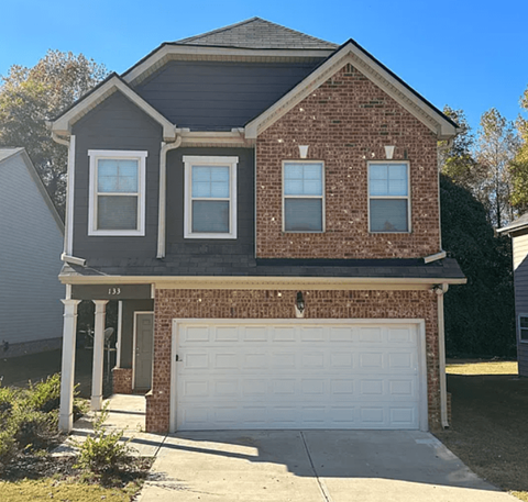 A two-story house with a garage.